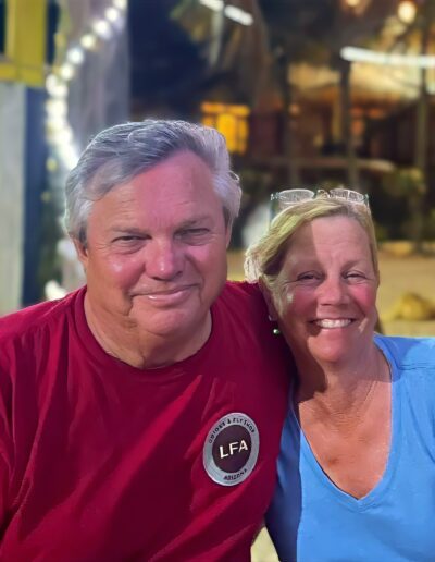 terry and wendy gunn on vacation Smiling couple posing together outdoors at night.