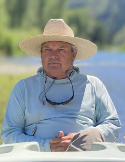 terry gunn taking it in Man in sun hat sitting by a river